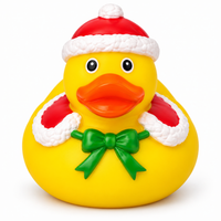 Mini christmas green bow rubber duck on a white background