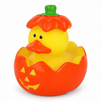 Mini halloween pumpkin rubber duck on a white background