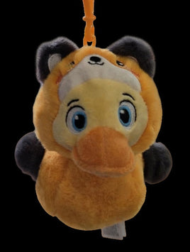 Plush keychain of a cartoon character with a visible brand tag on a black background