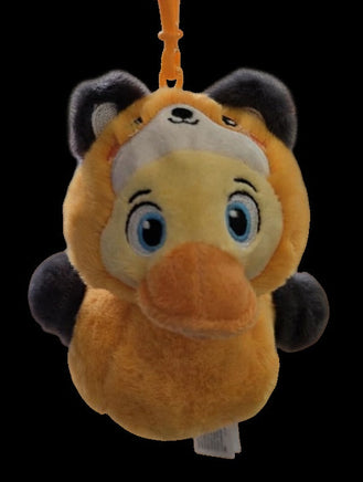 Plush keychain of a cartoon character with a visible brand tag on a black background